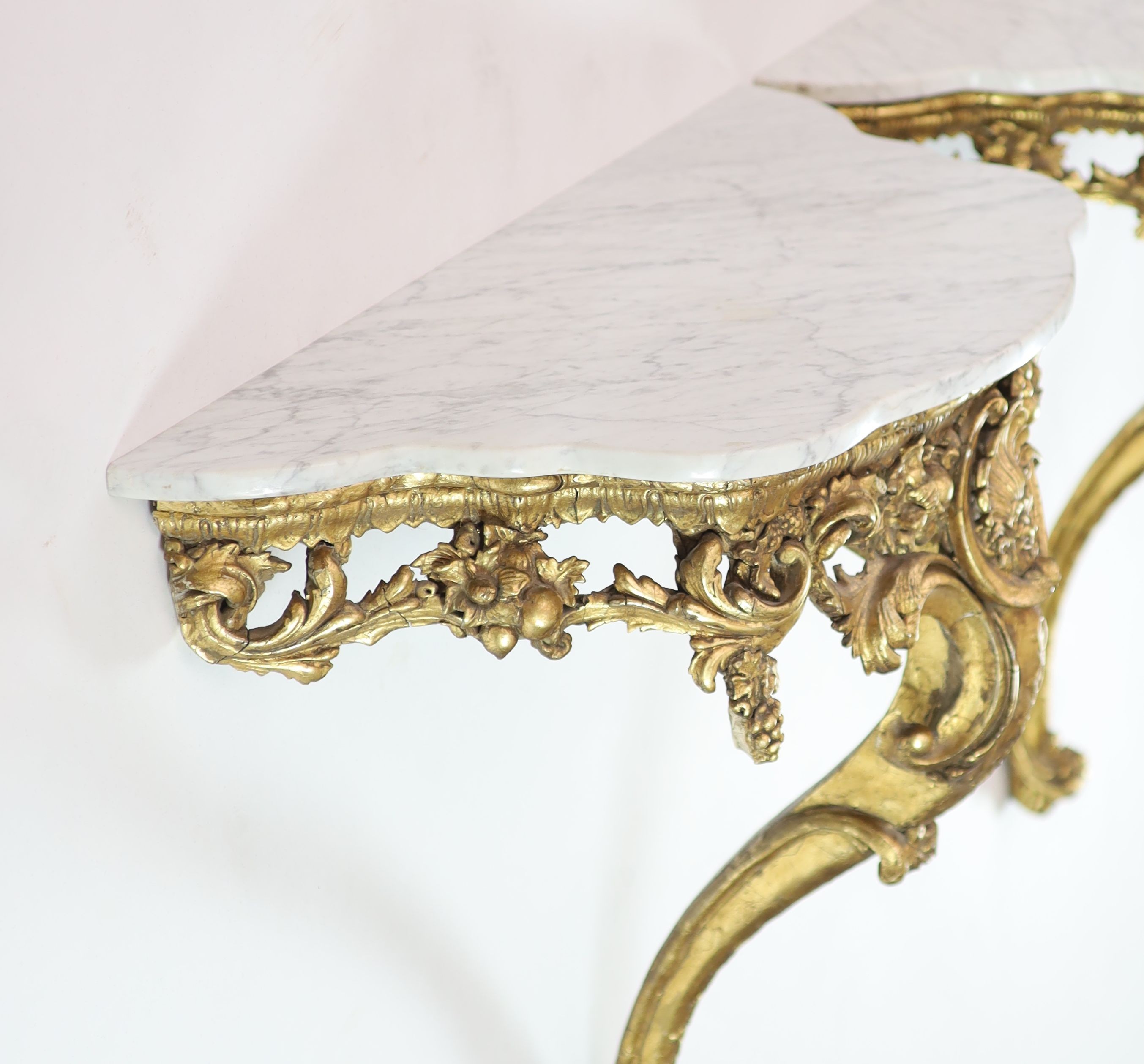 A pair of Louis XV style carved giltwood console tables H 84cm. W 98cm. D 42cm.
